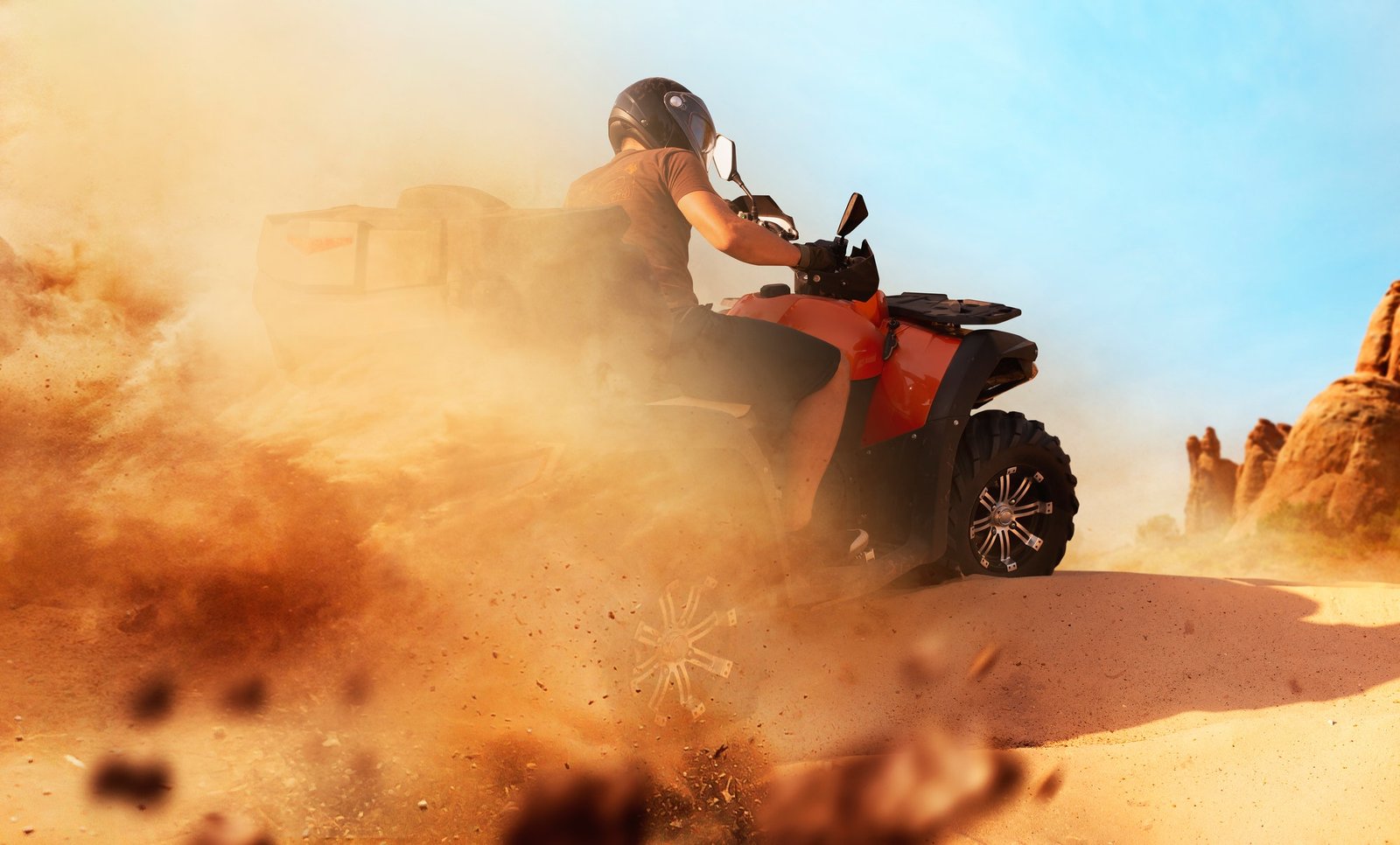 Atv riding in sand quarry, dust clouds, quad bike